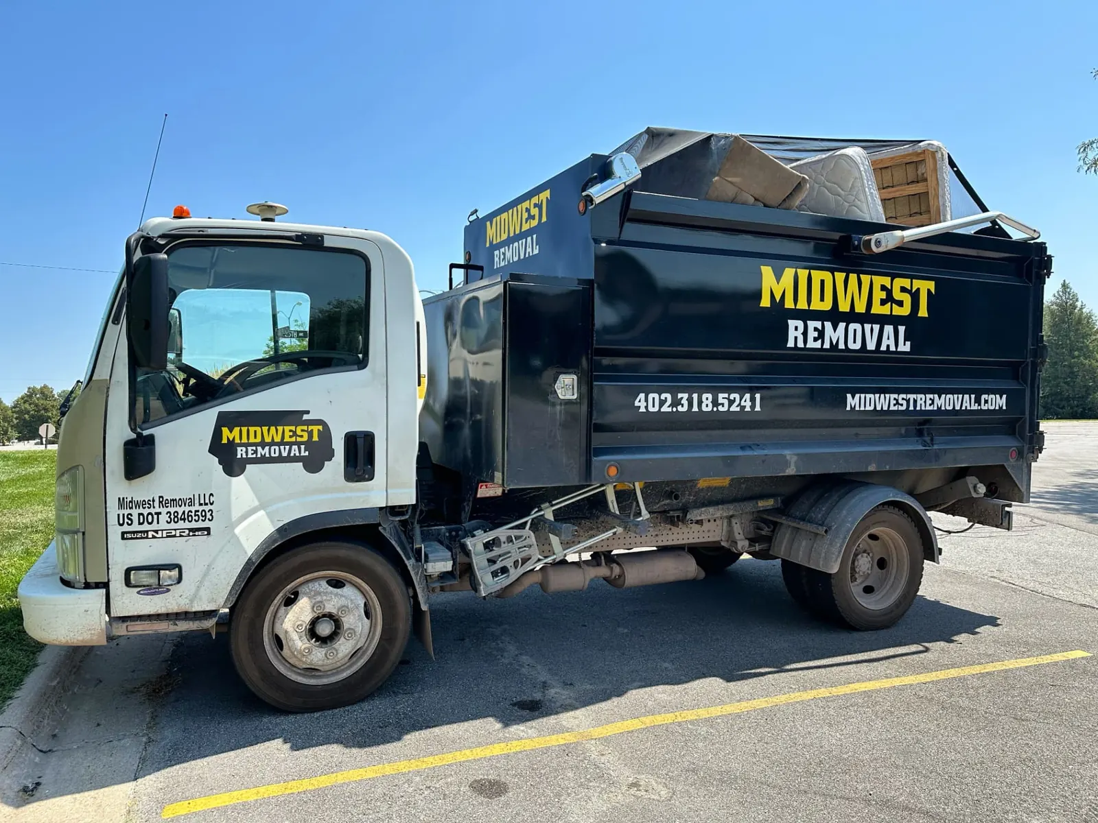 Midwest Removal truck loaded with appliances and furniture in Omaha