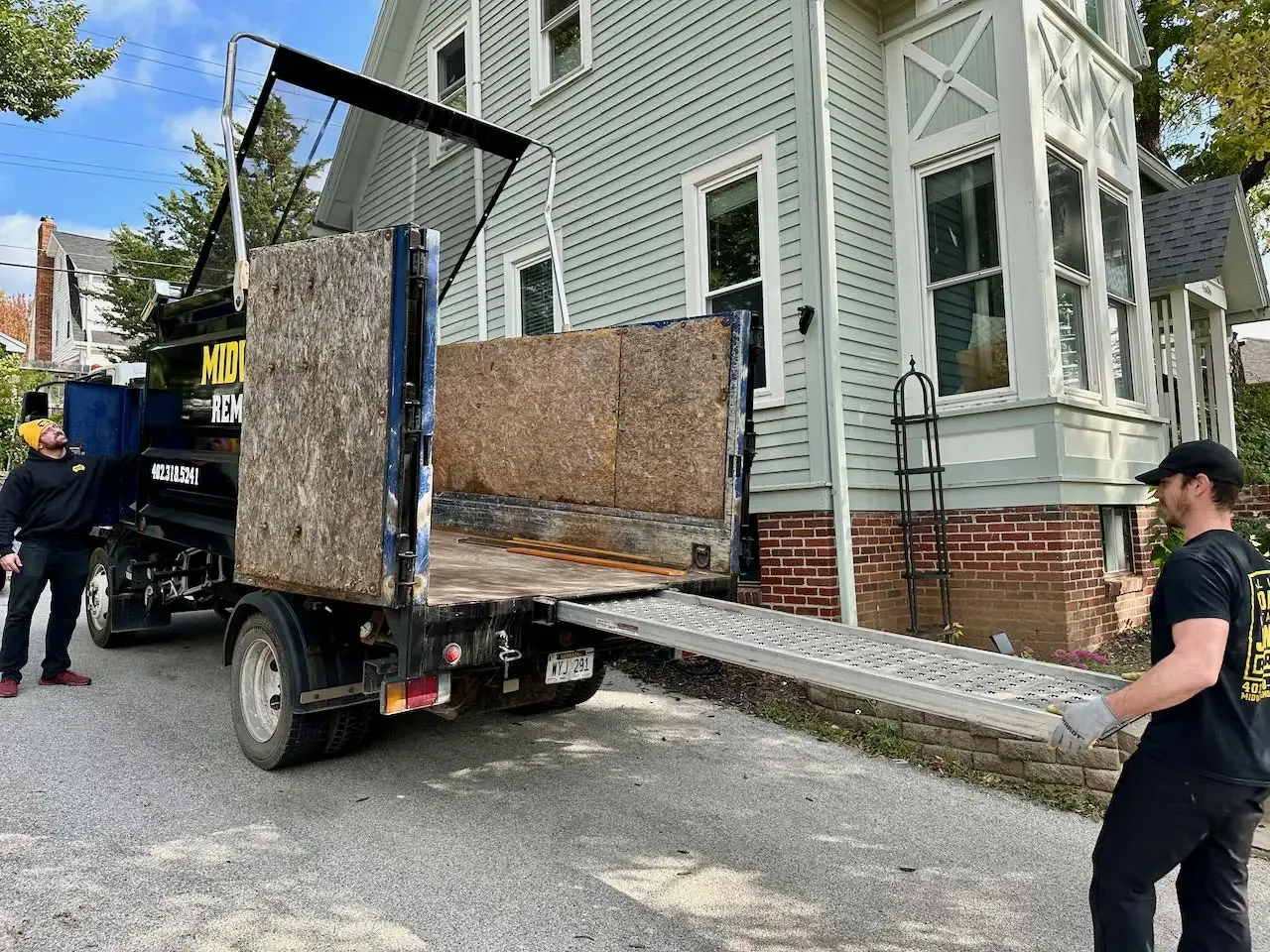 Loading bulky items up the truck ramp, Omaha
