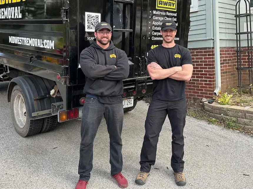 Midwest Removal crew standing in front of their branded truck in Omaha