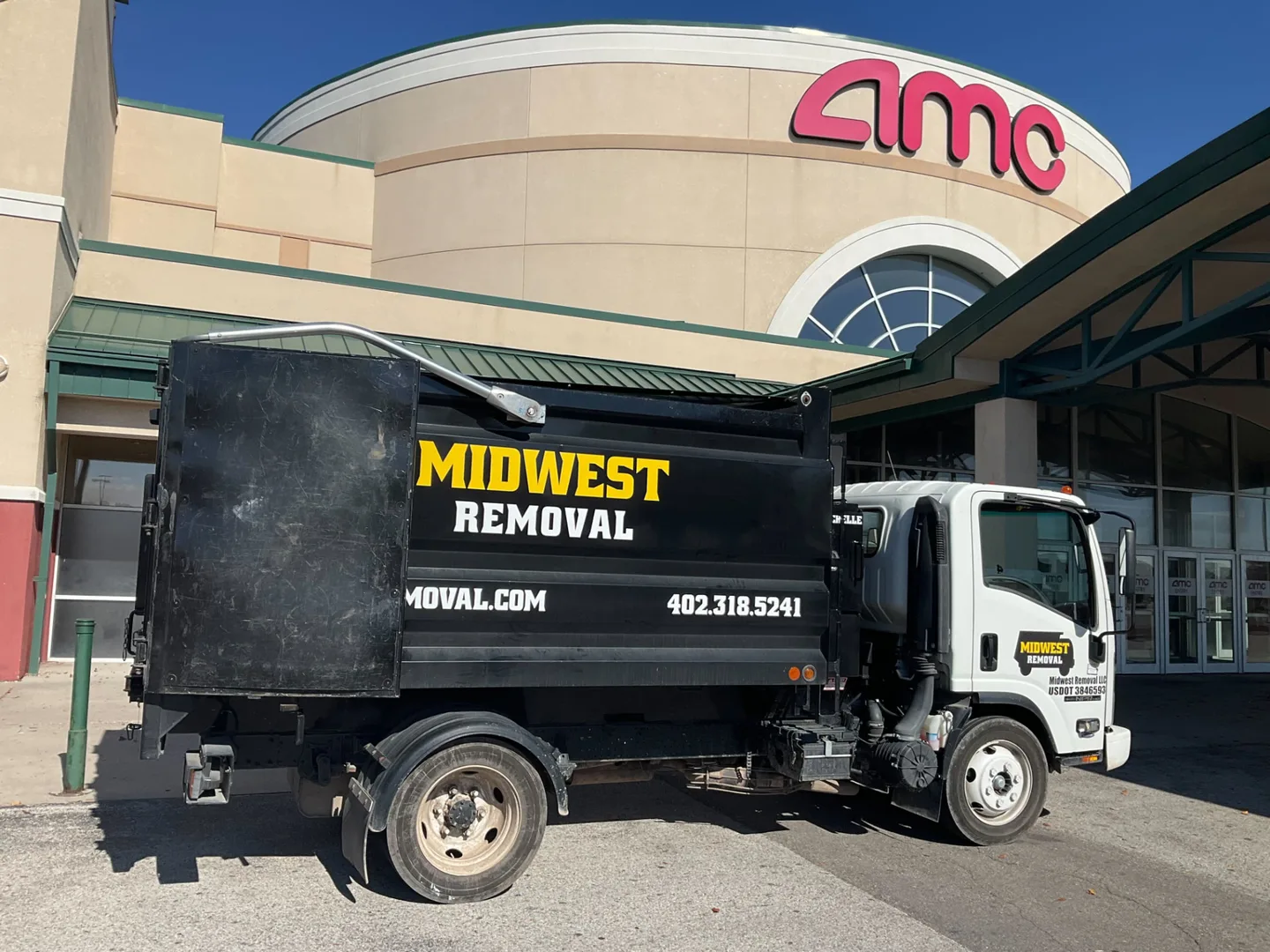 Midwest Removal truck outside a movie theater for a retail cleanout, Omaha