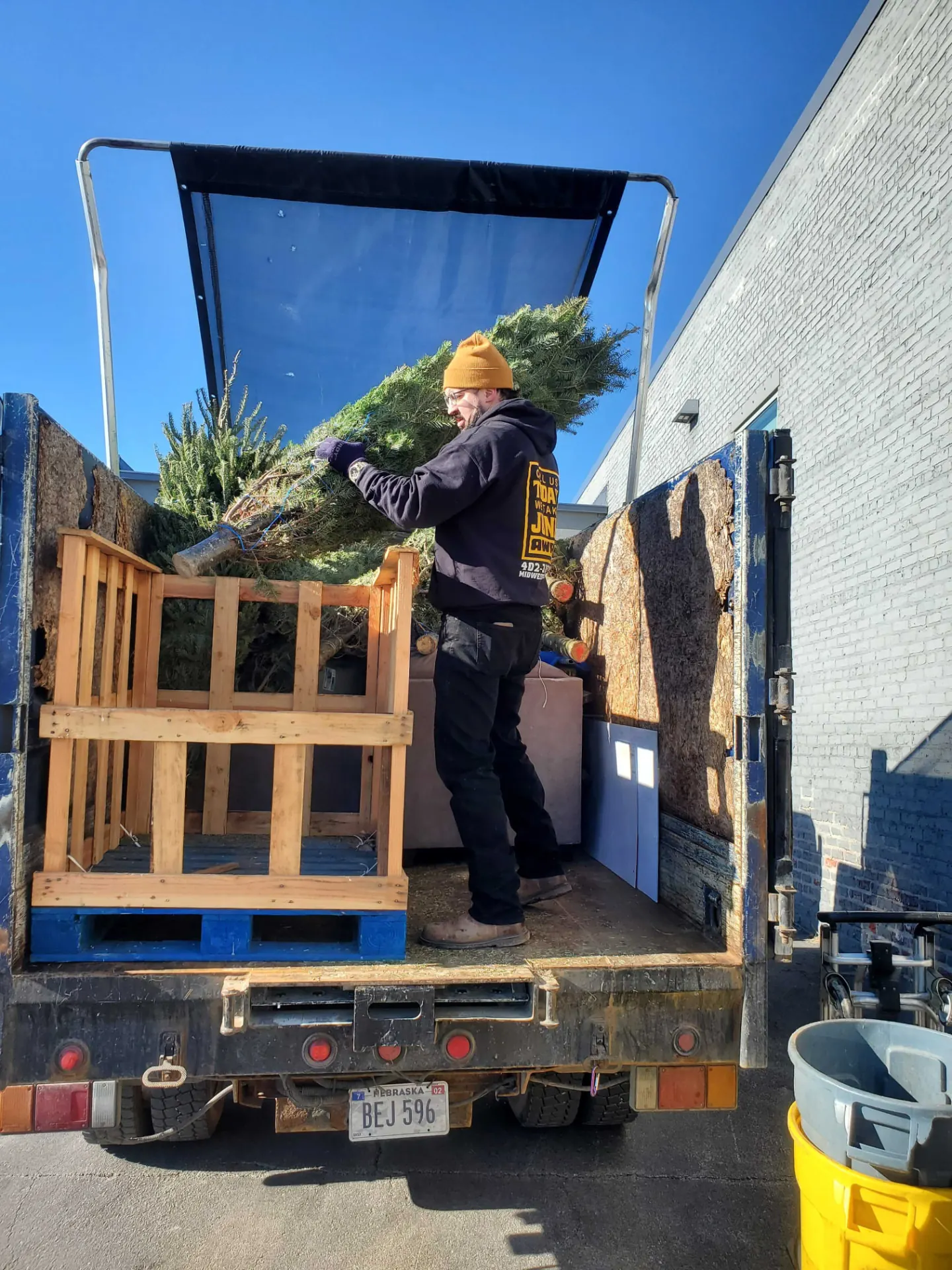 Midwest Removal crew member loading a tree and debris into the truck in Papillion