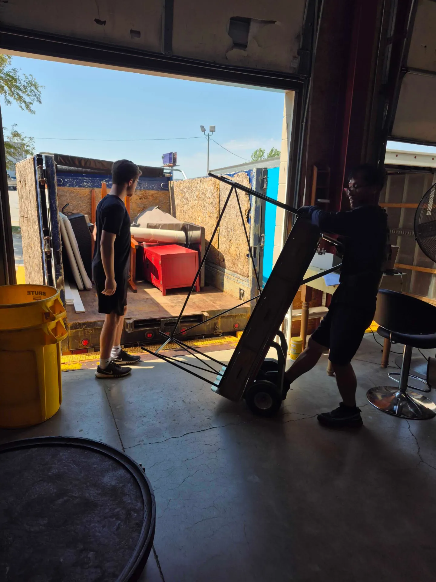 Crew wheeling furniture out to the truck during a Ralston cleanout