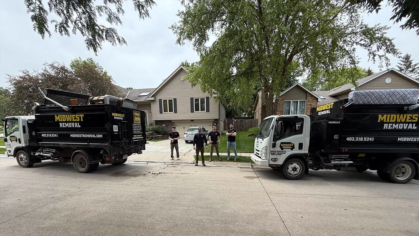 Trucks staged in a driveway for a cleanout, Omaha