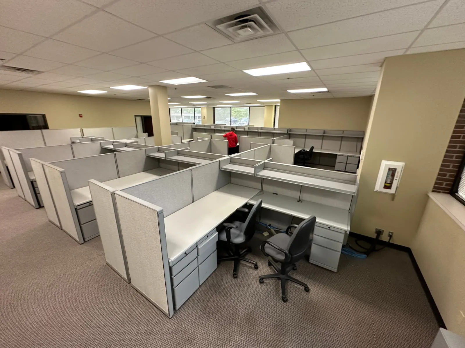 Crew clearing rows of office cubicles during an Omaha workspace cleanout