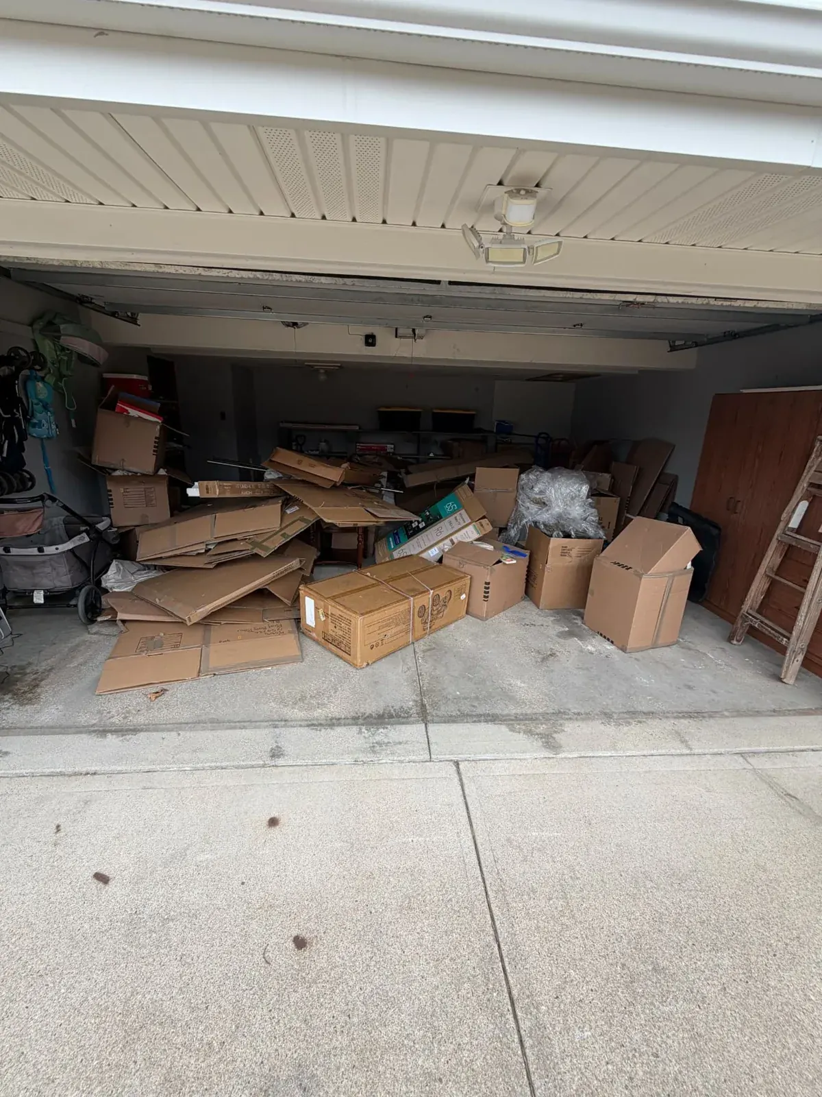Garage packed with boxes and cardboard before the cleanout, Omaha
