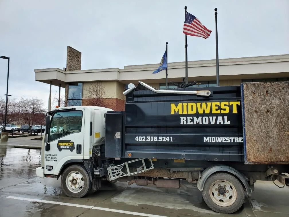 Midwest Removal truck parked outside a commercial building in Omaha