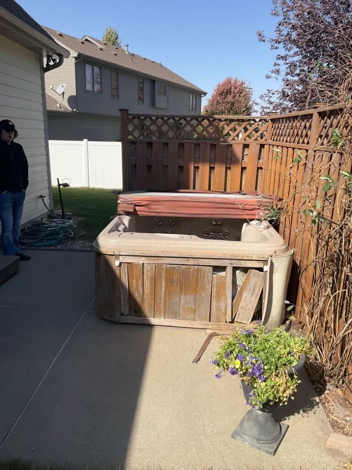 Weathered backyard hot tub before removal, Omaha