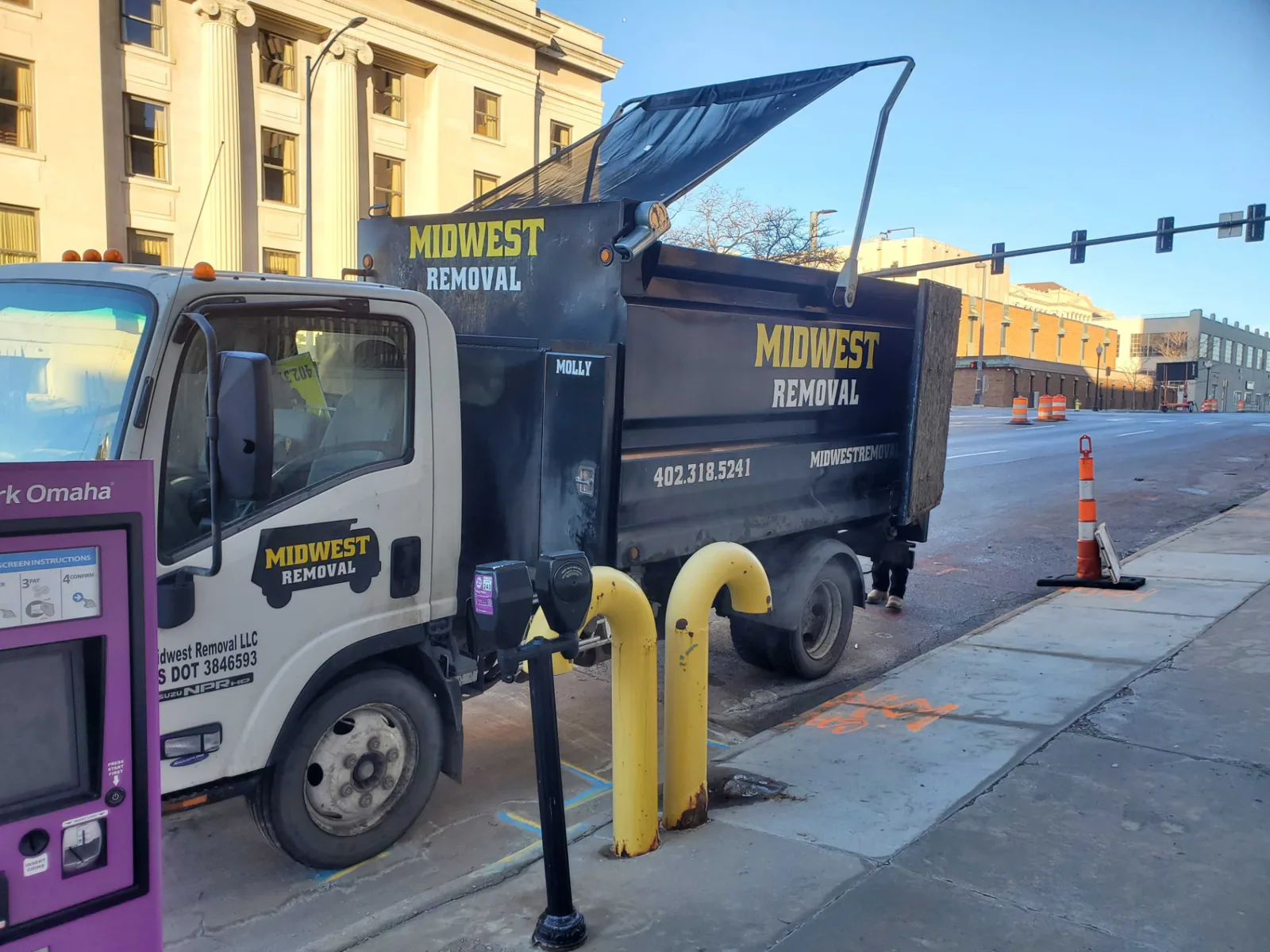 Loaded Midwest Removal truck on a downtown Omaha commercial job