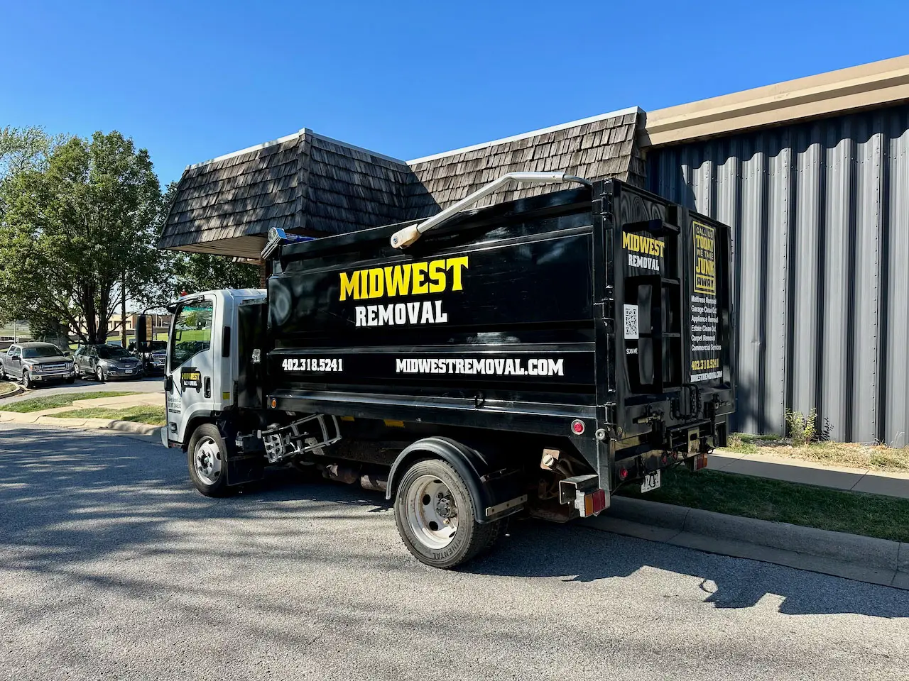 Midwest Removal truck loaded with tires and yard debris in Omaha