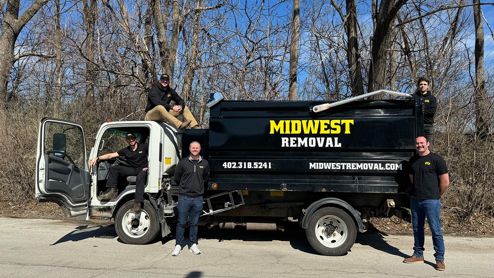 Midwest Removal crew beside a loaded junk removal truck in Omaha, NE